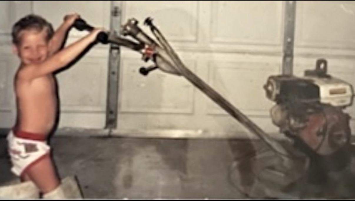 Syd as a young child at the controls of concrete finishing equipment