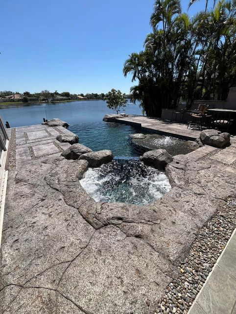 Hand-carved, stamped and stained concrete pool deck by Crete Concepts in Southwest Florida