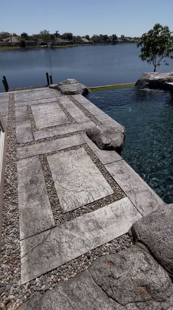 Stamped walkway with river rock borders by Crete Concepts in Southwest Florida