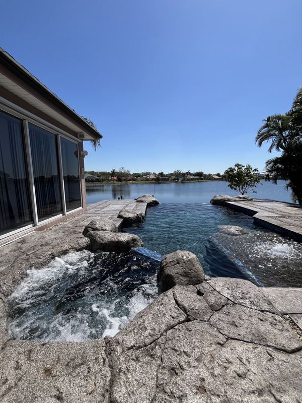 Hand-carved stone pool deck on the lake, Crete Concepts, Southwest Florida