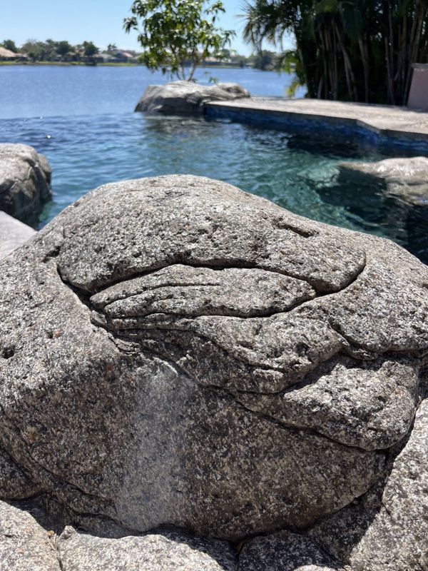 Hand-carved rock detail at the water's edge, Crete Concepts, Southwest Florida