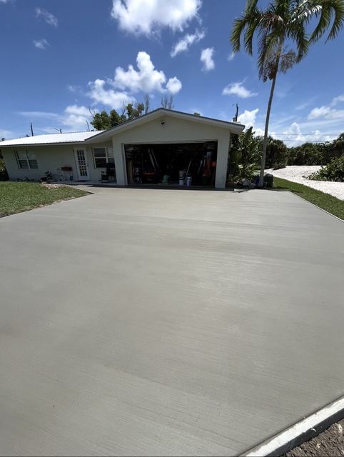 Wide new driveway to the garage by Crete Concepts in Southwest Florida