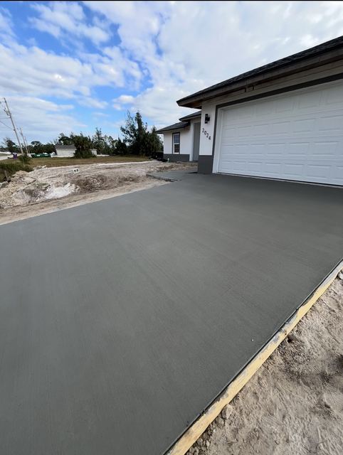 Fresh driveway along the garage by Crete Concepts in Southwest Florida