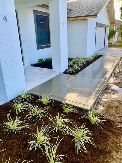 Entry walkway with new plantings by Crete Concepts in Southwest Florida