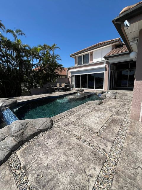Stamped pool deck with carved rock by Crete Concepts in Southwest Florida