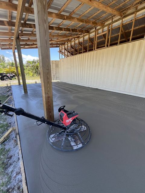 Power-troweling a big slab by Crete Concepts in Southwest Florida